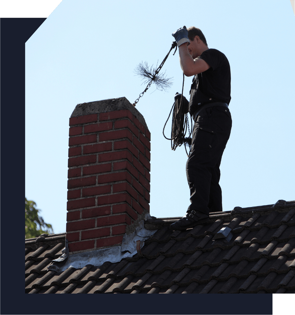 chimney sweep technician cleaning a residential chimney