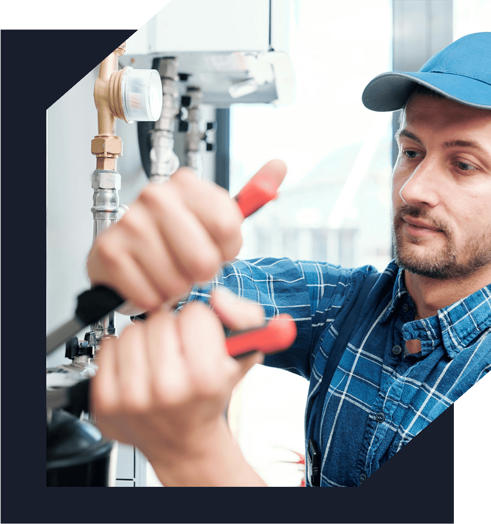 Plumber using pliers on pipe