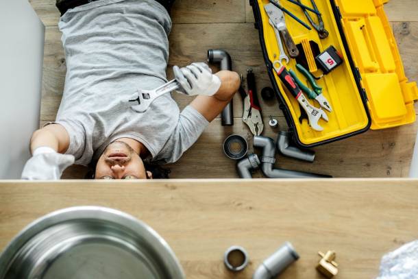 plumber fixing the sink